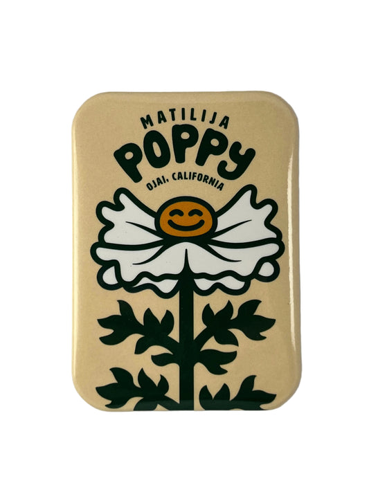 Magnet with a stylized poppy flower and text on a beige background